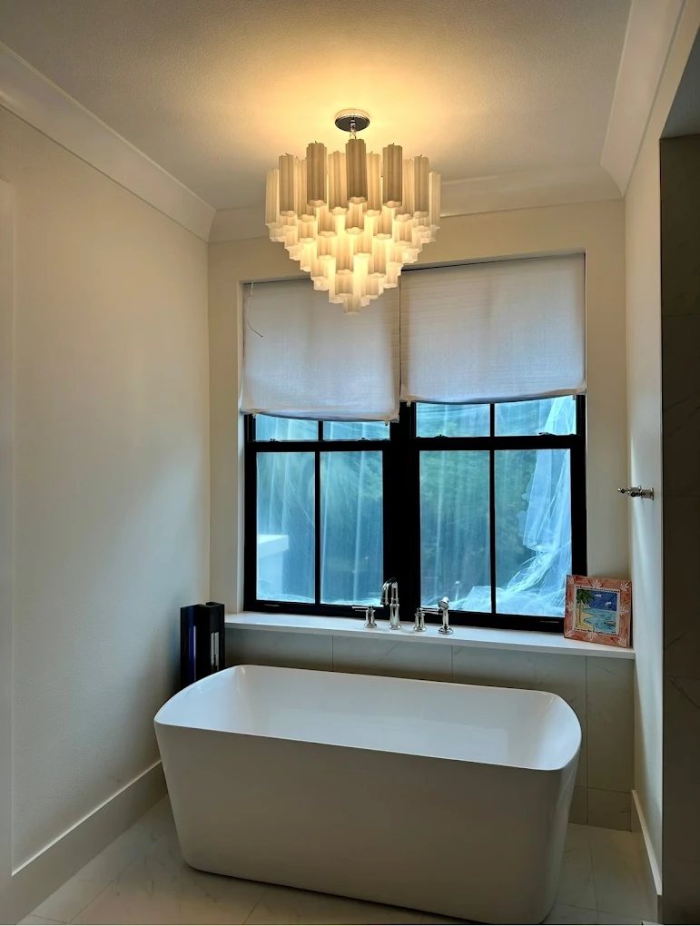 Bathroom chandelier installed above a freestanding tub
