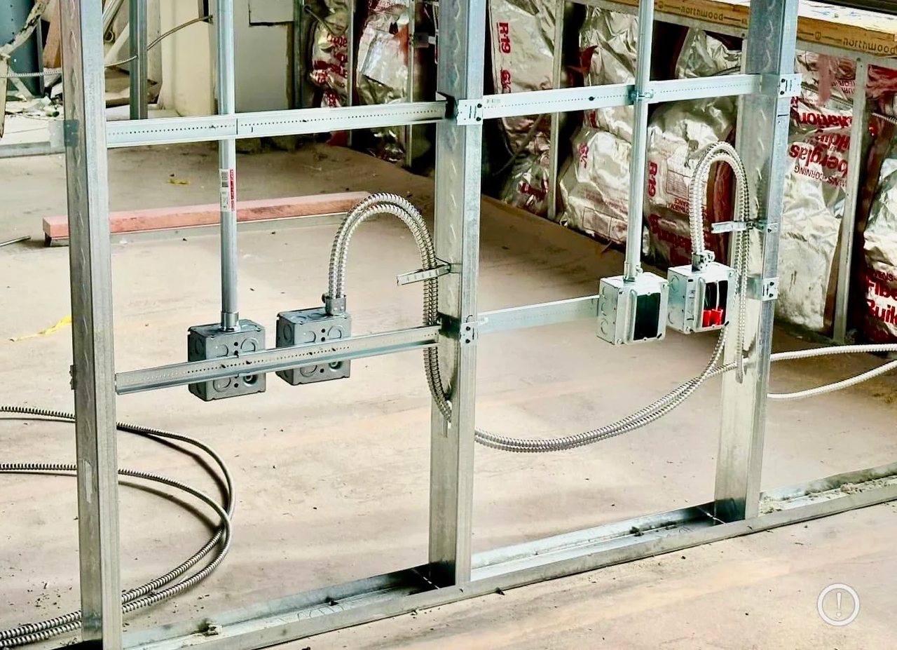 Commercial electrical rough-in with metal stud framing and MC cable