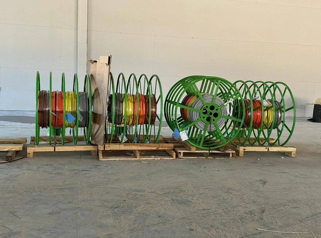 Colour-coded wire spools staged on a Carter Electric commercial jobsite