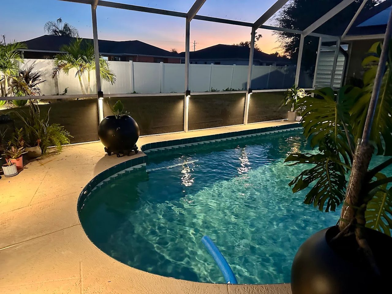 Pool cage and lanai lighting installed by Carter Electric at dusk in Southwest Florida